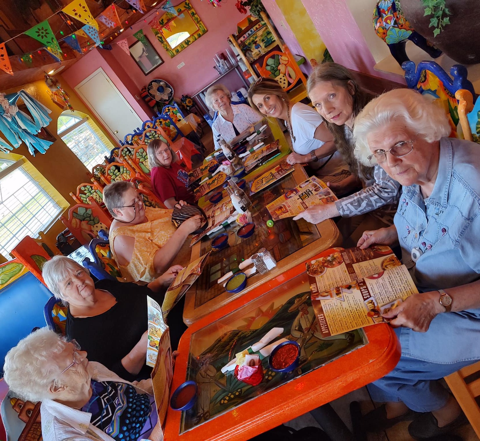Residents enjoying a meal together in a colorful dining area