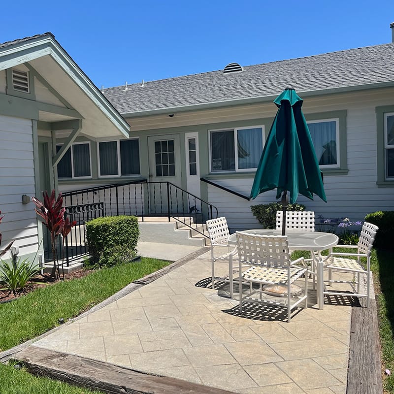 Outdoor patio area with seating and umbrella
