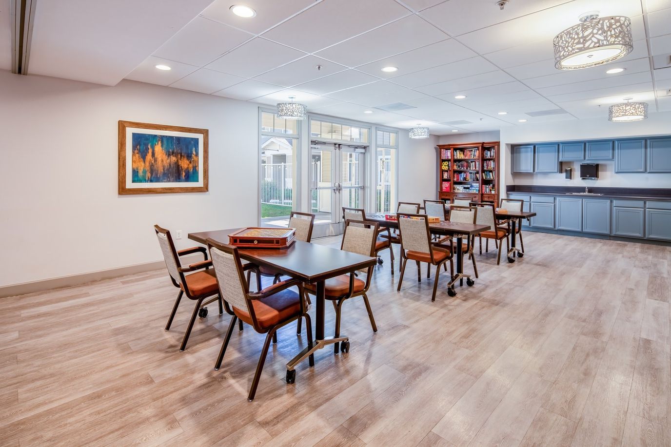 Bright and spacious common area with tables and chairs
