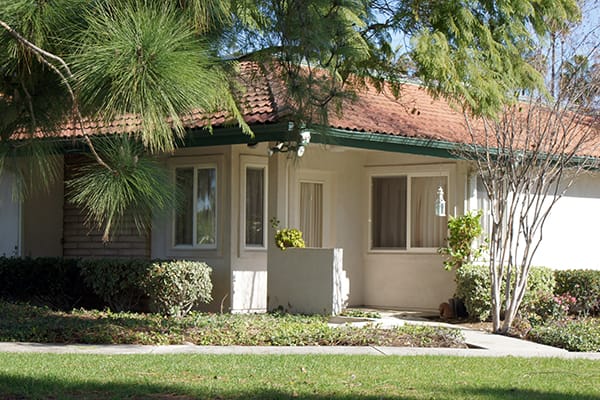 Exterior view of a senior living facility with greenery