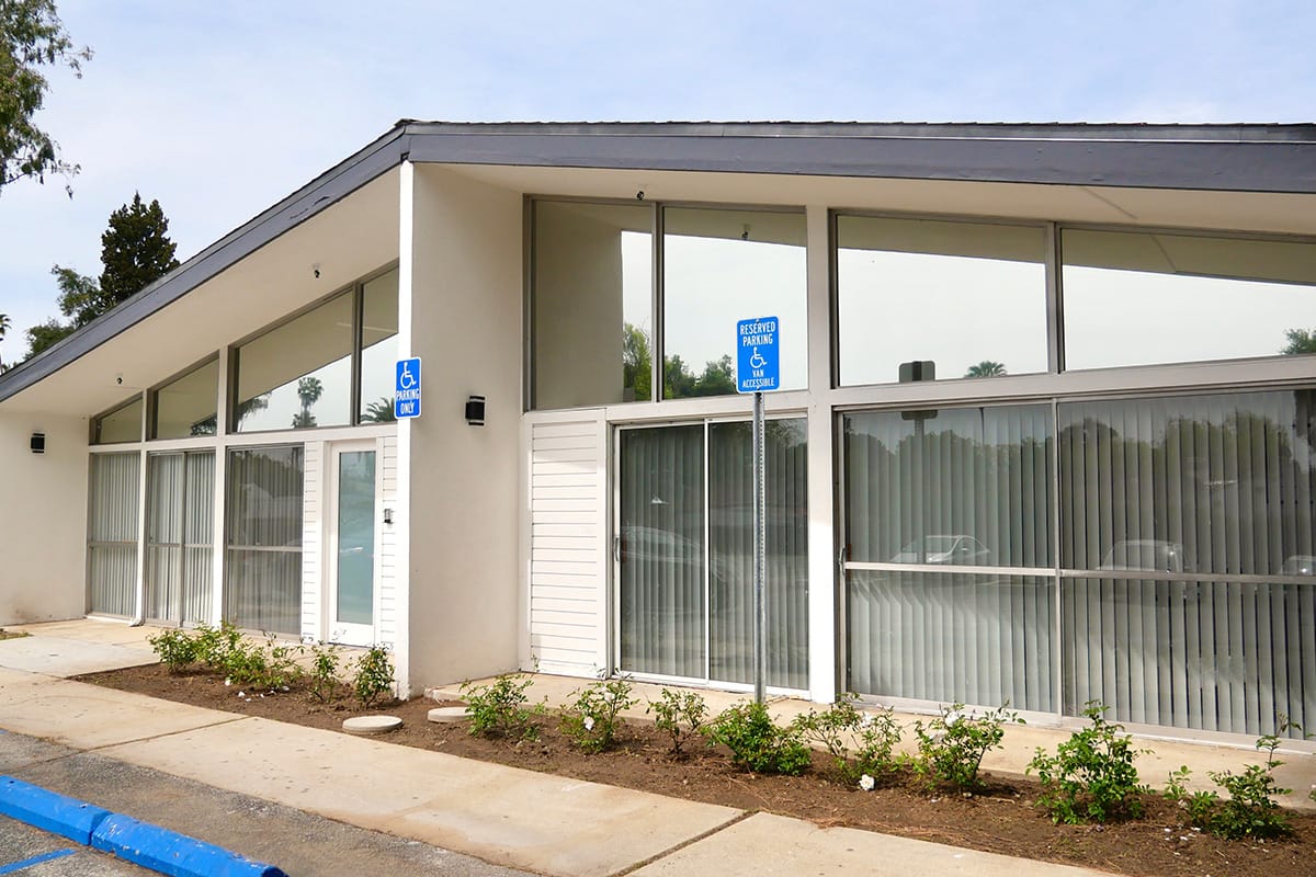 Exterior view of a senior living facility with accessible parking