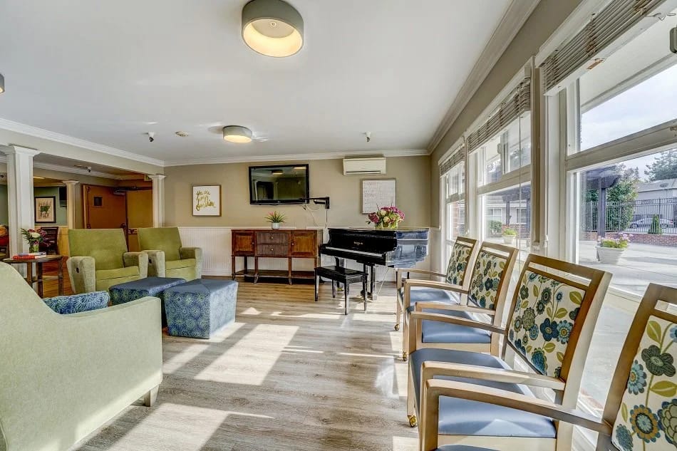 Bright common area with seating and a piano
