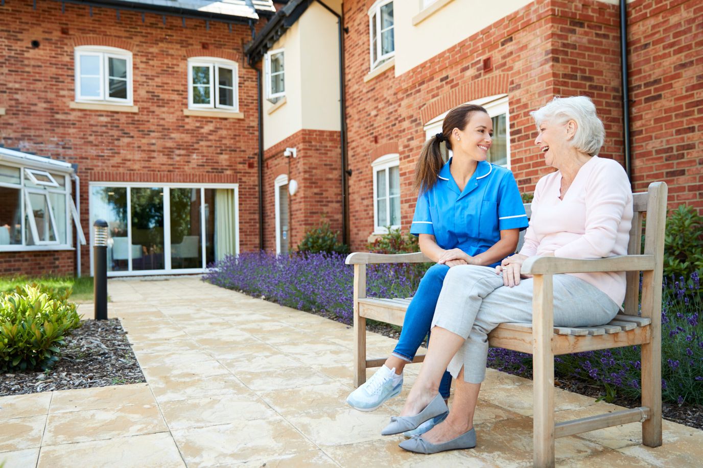 Staff member chatting with a resident in the garden