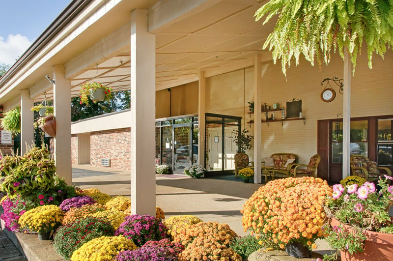 Exterior view of the facility entrance with flowers