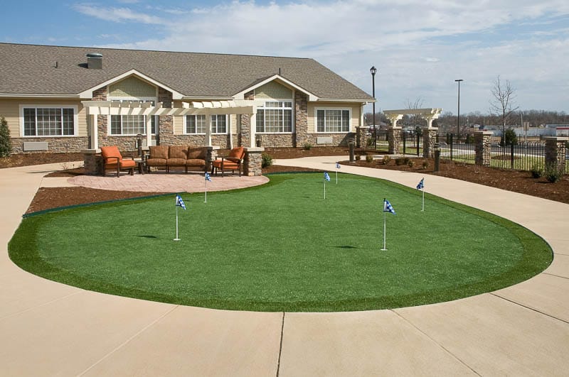 Outdoor putting green with seating area