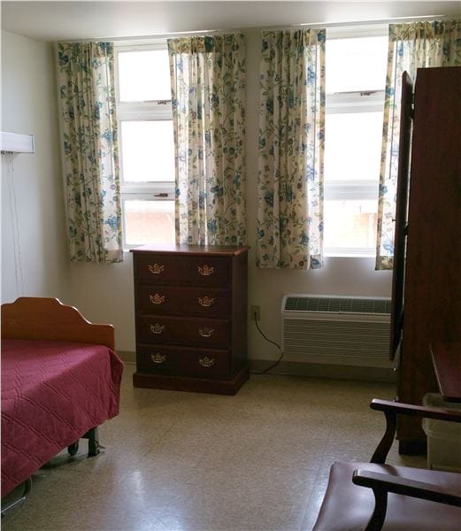 Private resident room with a bed and dresser