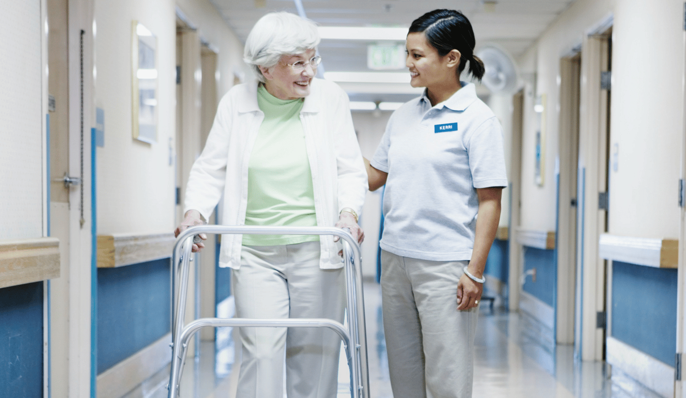 Staff assisting a resident in a hallway