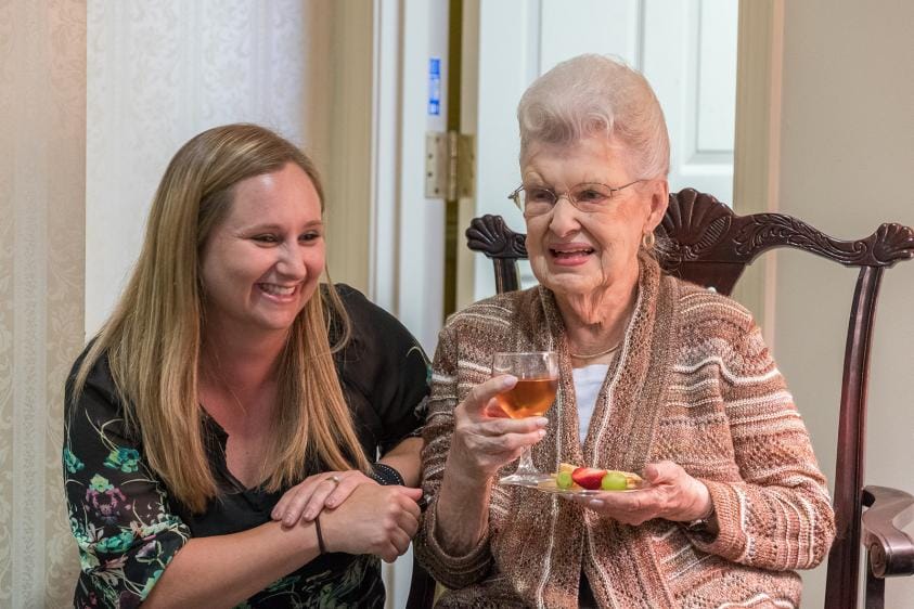 A staff member enjoying time with a resident