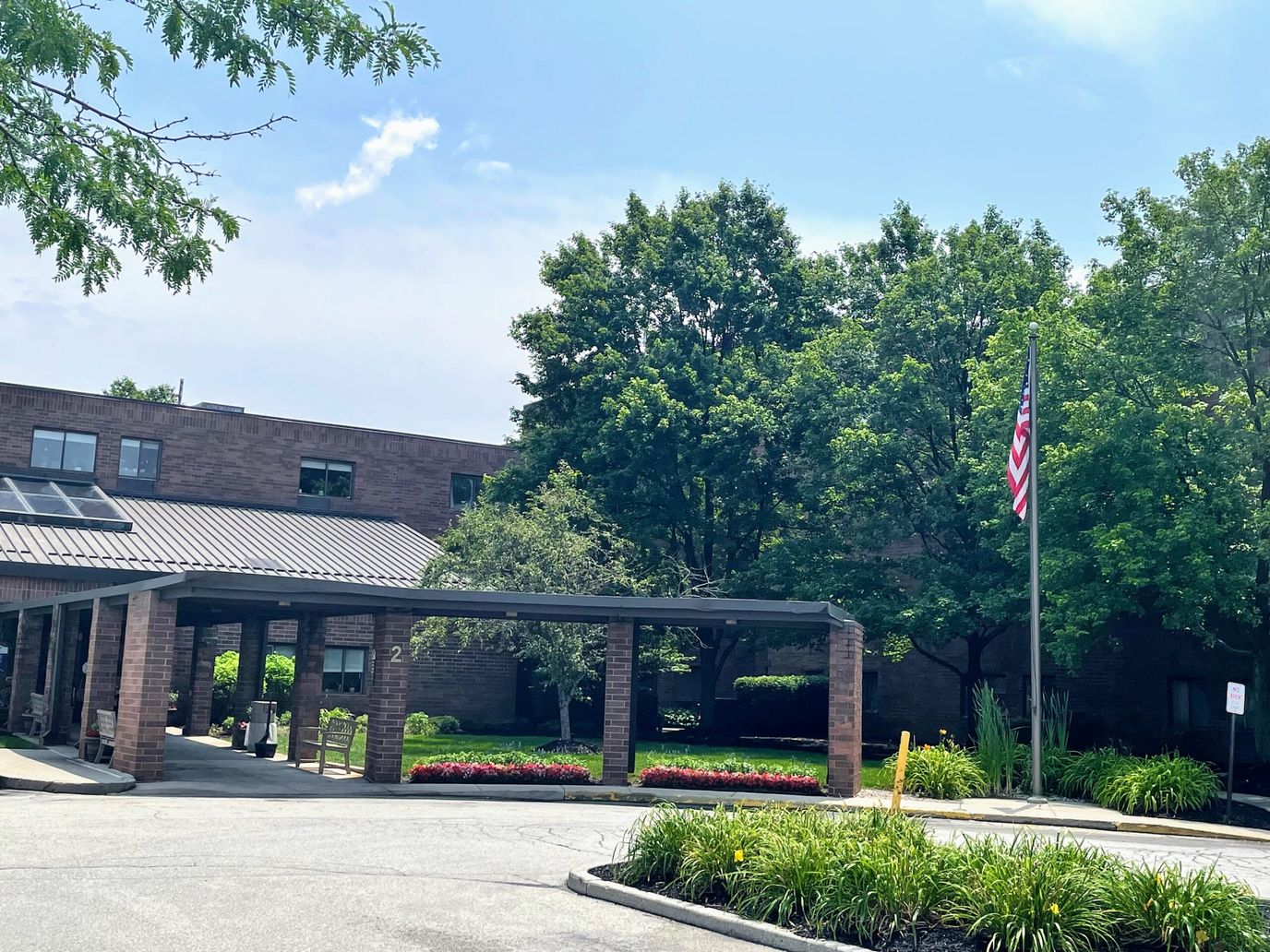 Facility entrance with landscaping and American flag