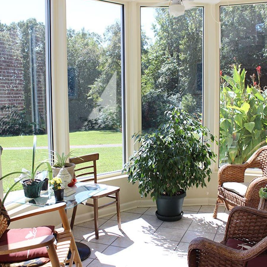 Bright sunroom with plants and seating