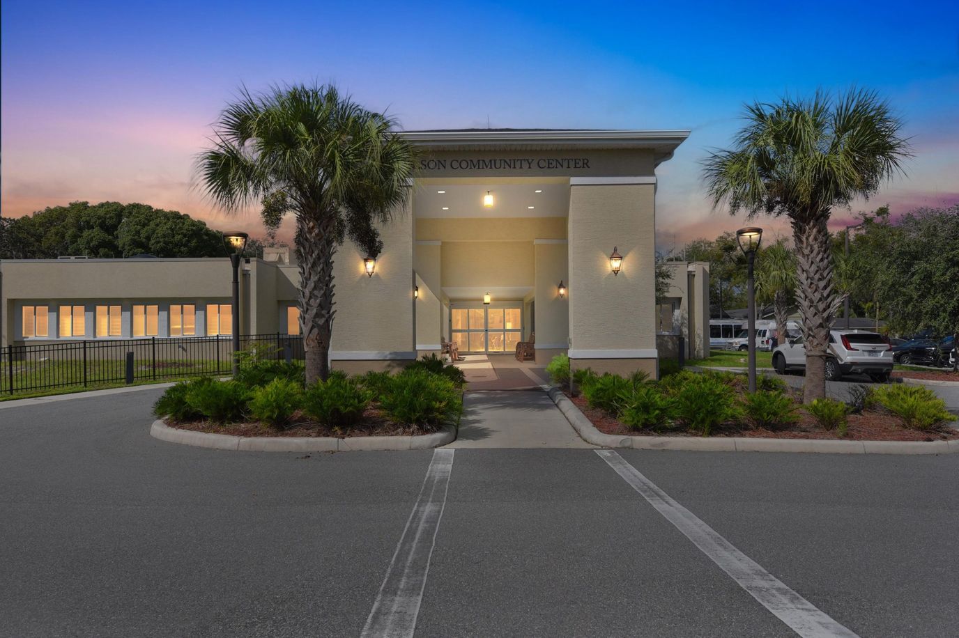 Front entrance of the community center with palm trees