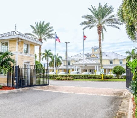 Entrance view of The Brennity at Melbourne with palm trees