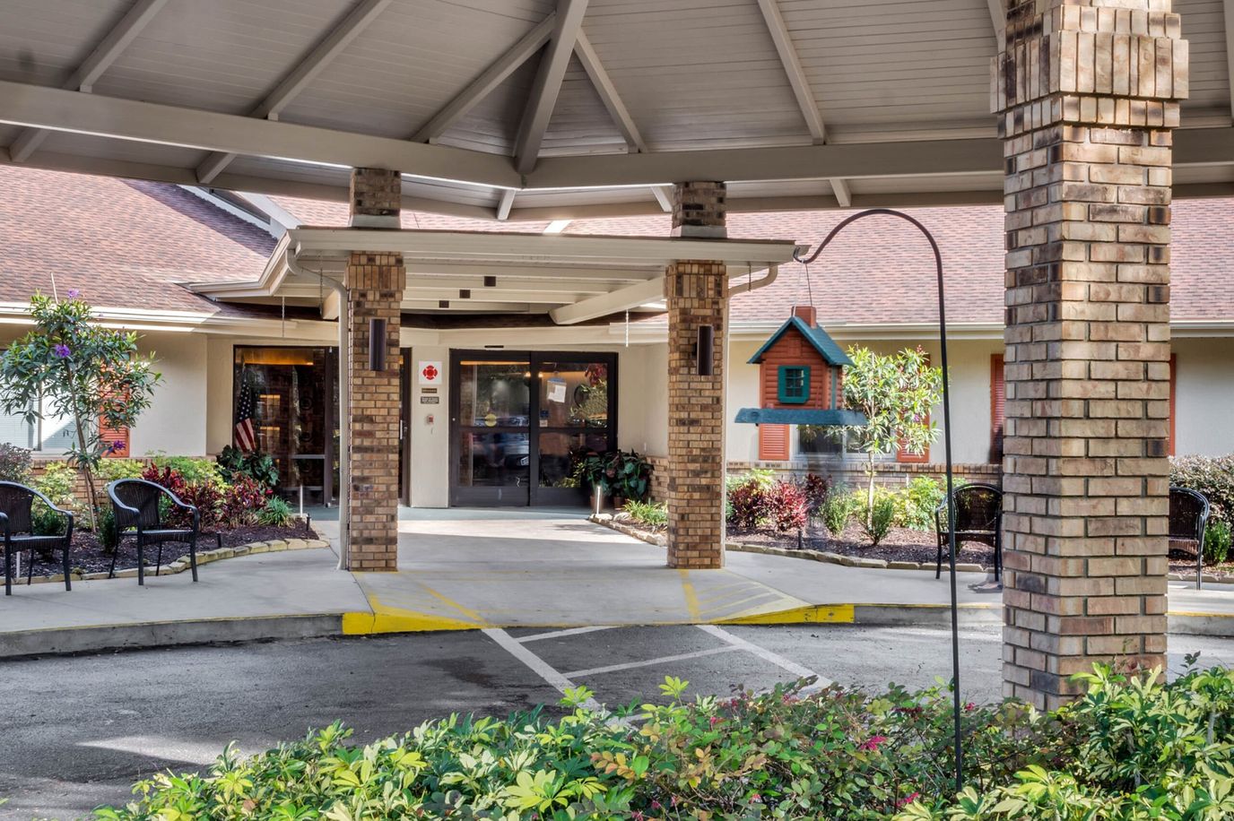 Entrance area with covered seating and birdhouse