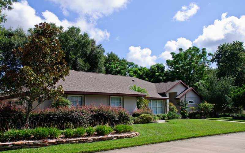 Exterior view of a senior living facility with greenery