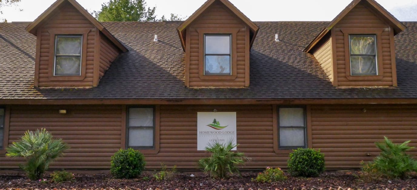 Exterior view of Homewood Lodge with branding