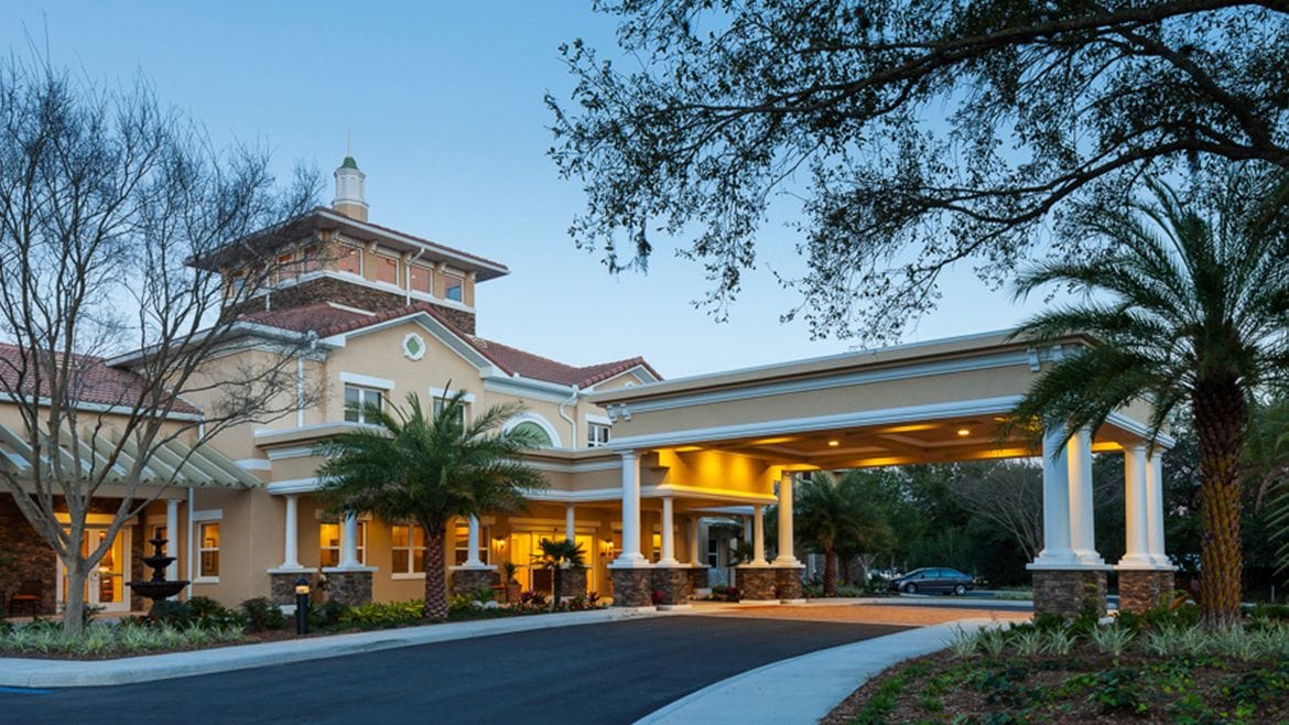 Exterior view of the facility entrance with palm trees