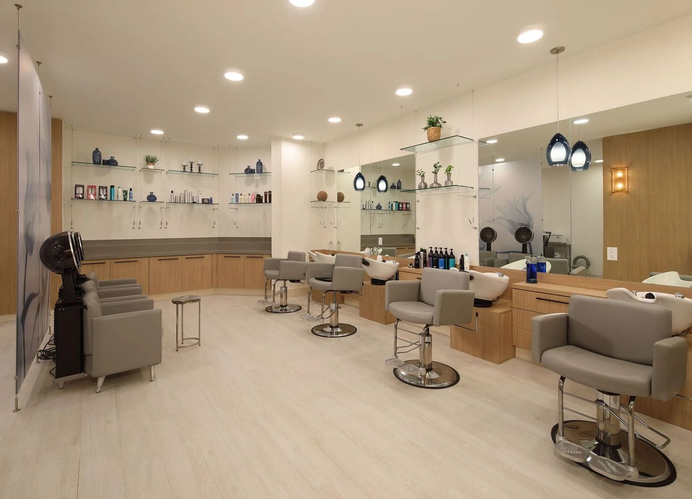A salon area with styling chairs and mirrors
