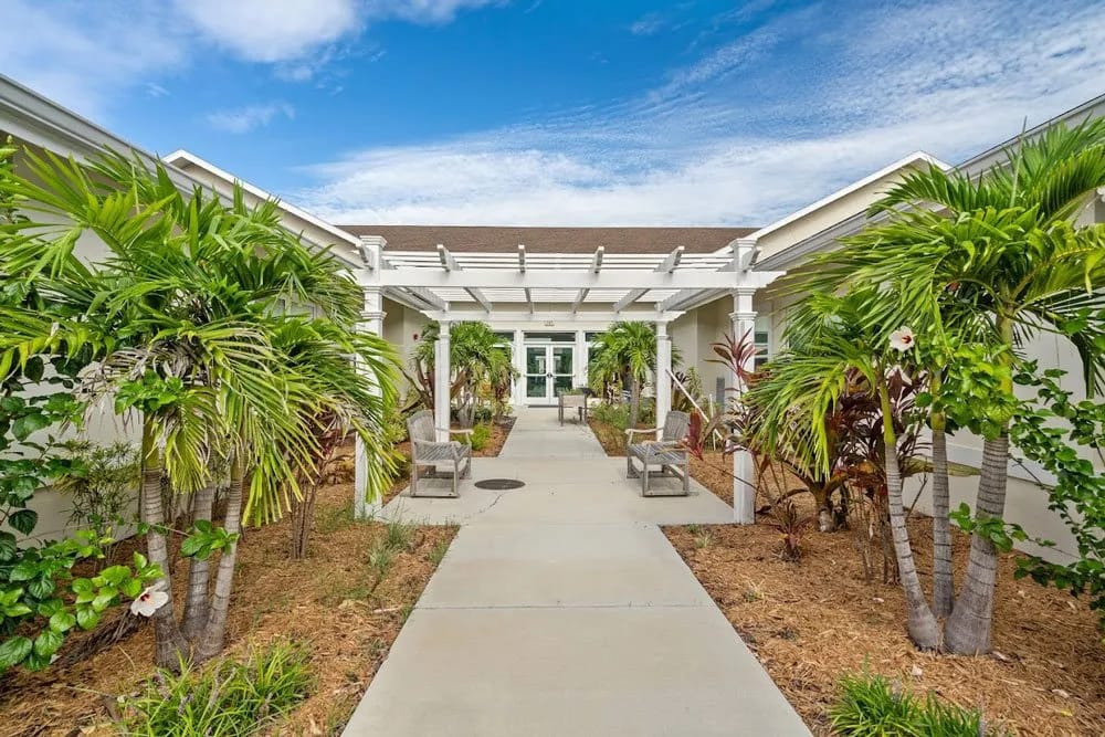 Entrance walkway surrounded by tropical plants