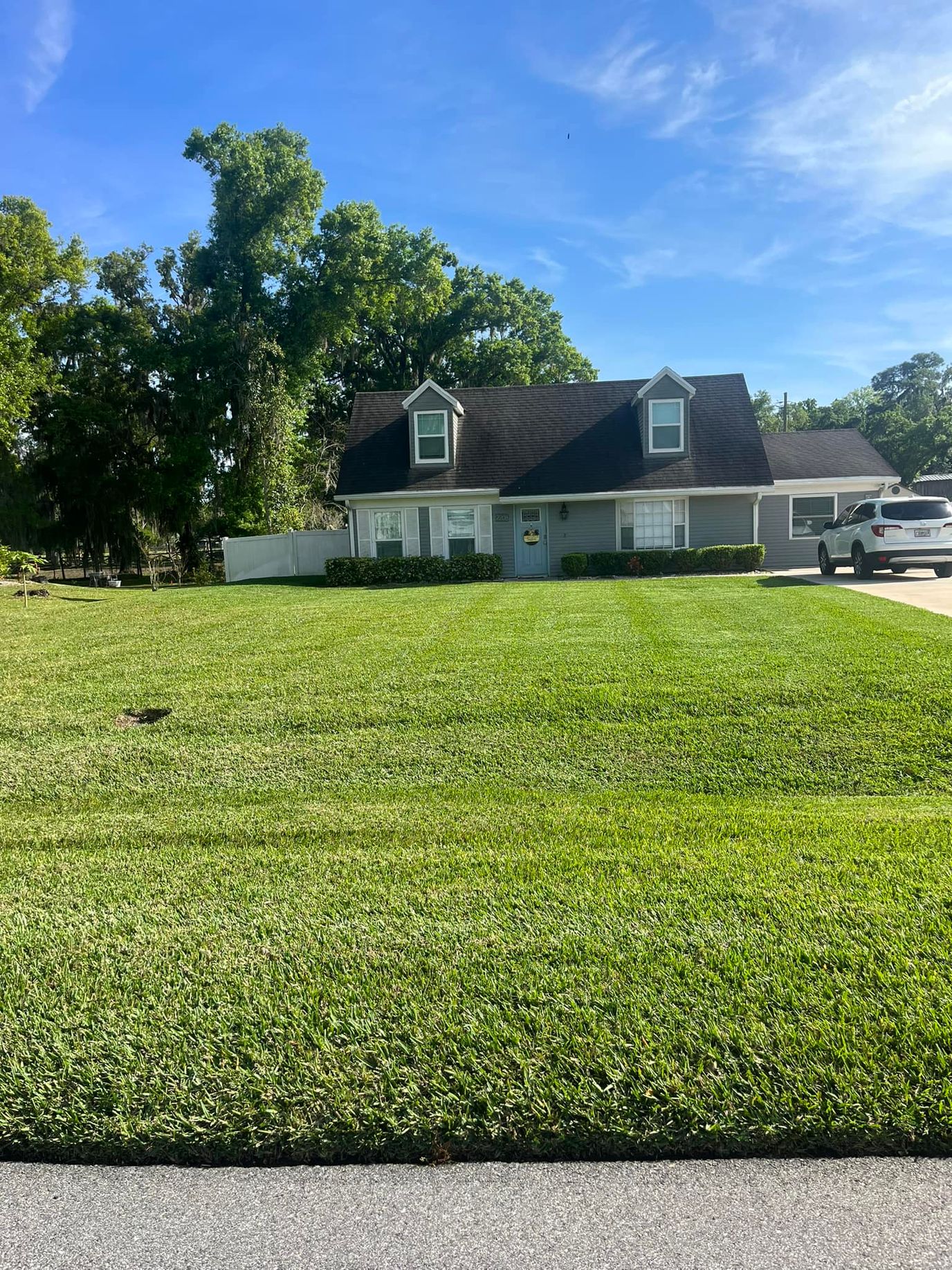 Exterior view of a senior living facility with well-kept lawn