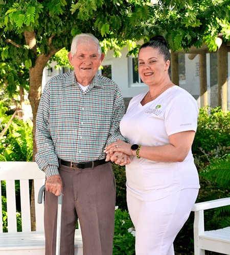 A staff member assisting a resident outdoors