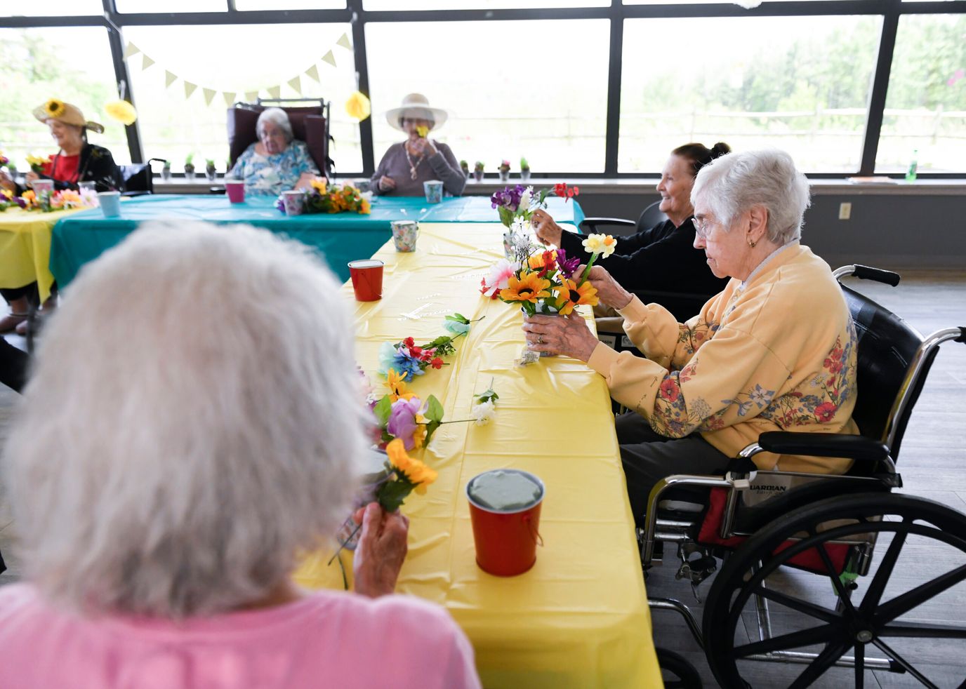 Residents engaging in a flower arrangement activity