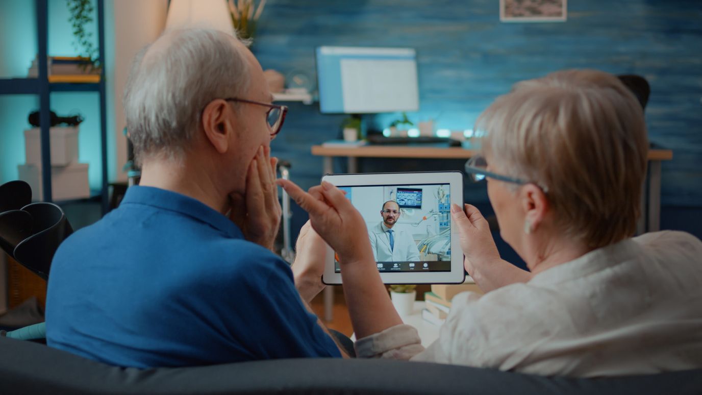 Two seniors using a tablet for a video call