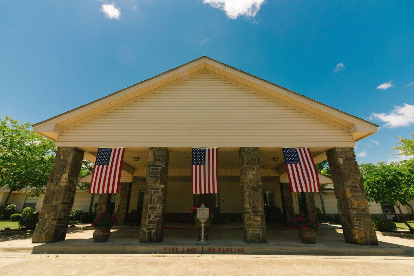 Front entrance of Southridge Village Retirement Center with flags