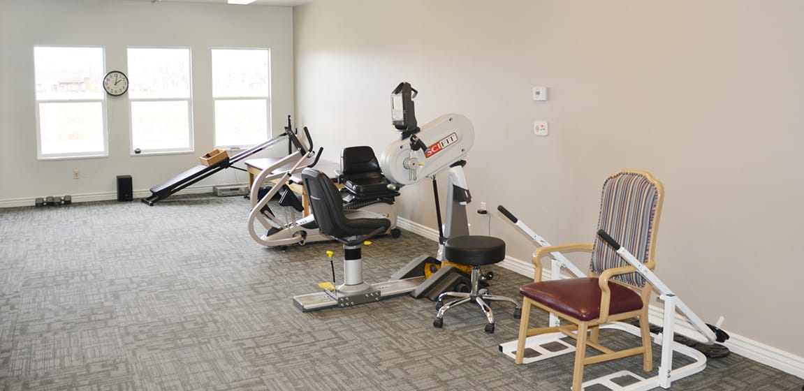 Interior view of a rehabilitation exercise room with equipment