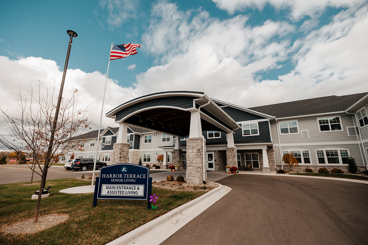 Exterior view of a senior living facility with flag