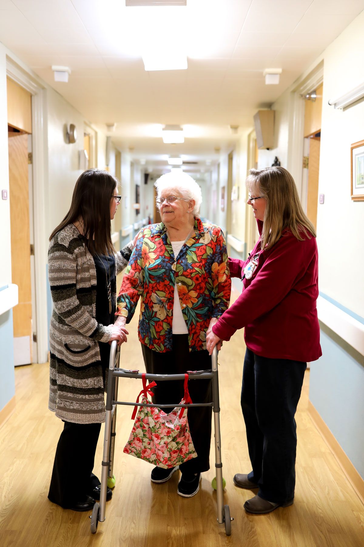 Staff assisting a resident in a hallway