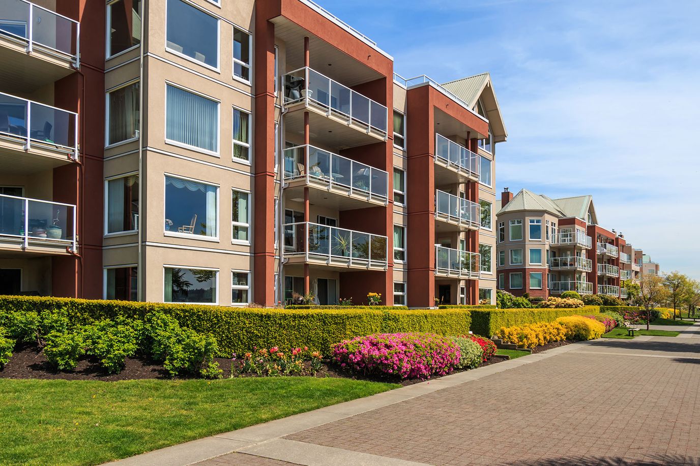 Exterior view of colorful residential buildings with gardens