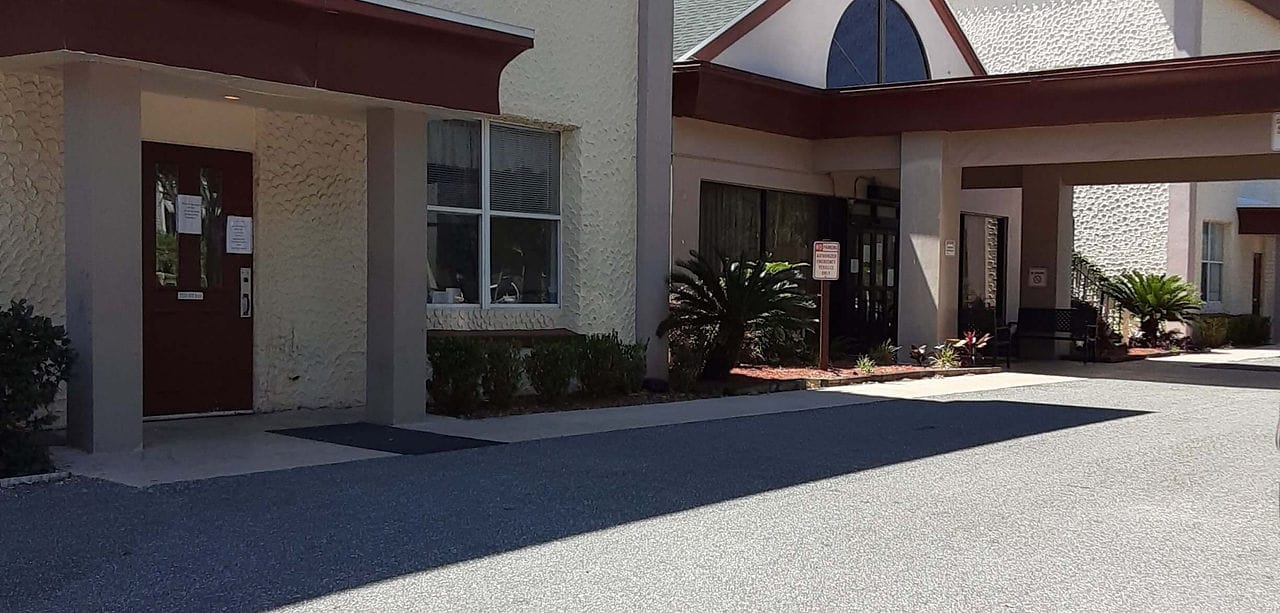 Building entrance of Elevated Estates with landscaping