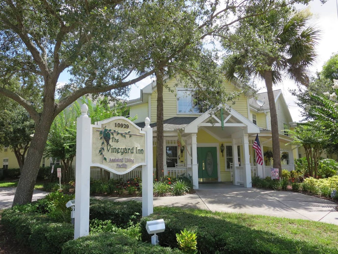 Exterior view of The Vineyard Inn building with signage