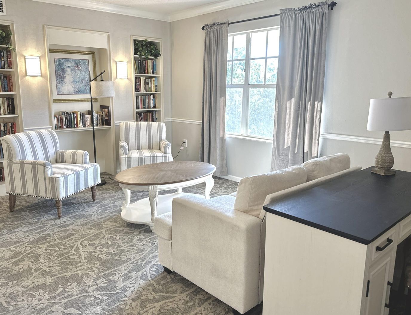 Cozy common area with seating and bookshelves
