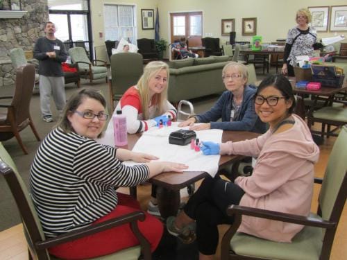 Residents engaged in a nail painting activity.