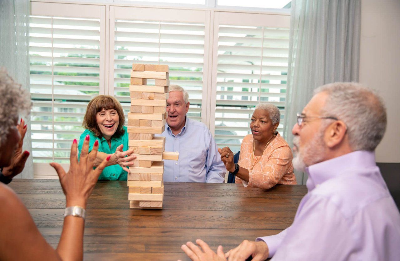 Residents enjoying a game at a communal table.