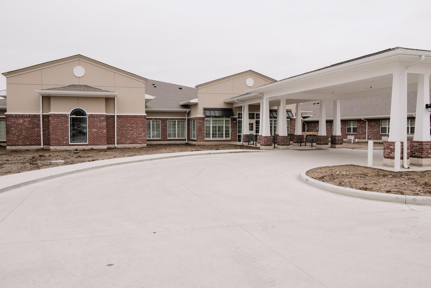 Entrance of a senior living facility with a curved driveway