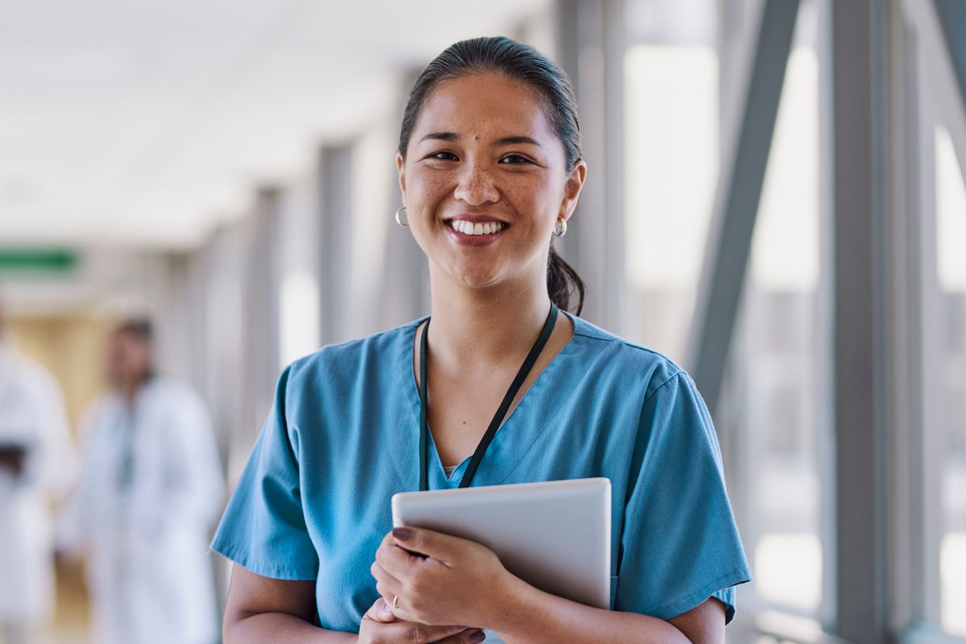 Staff member smiling in a facility corridor.