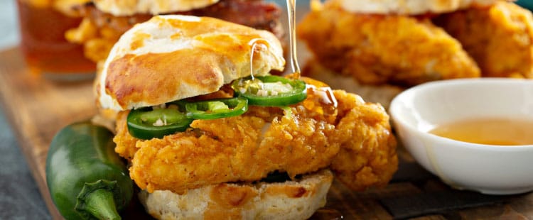 Close-up of fried chicken sandwiches with jalapeños