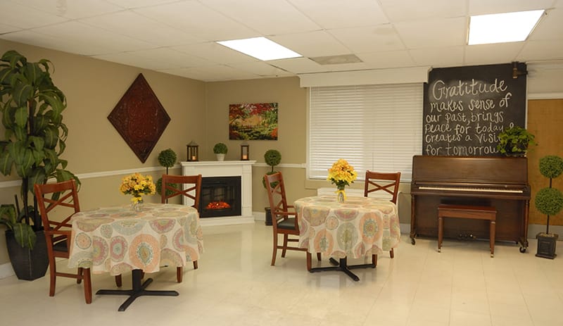 Warm common area with tables and decor.
