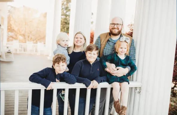 Family gathering on a porch with columns