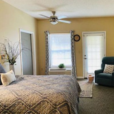 Cozy resident room with a bed and seating area