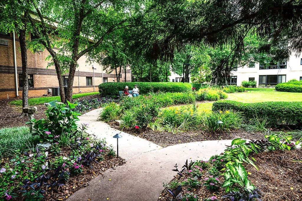 Montclair Assisted Living, assisted living in Decatur, GA — Lush garden path with seating areas and greenery