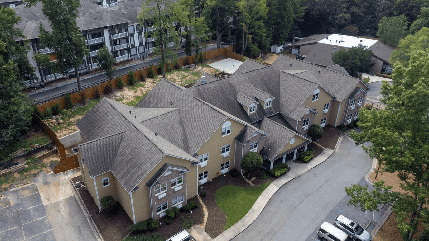 Aerial view of a senior living facility surrounded by greenery