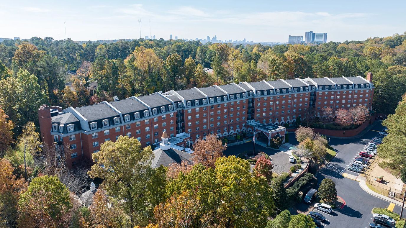 Aerial view of the retirement center with surrounding trees.