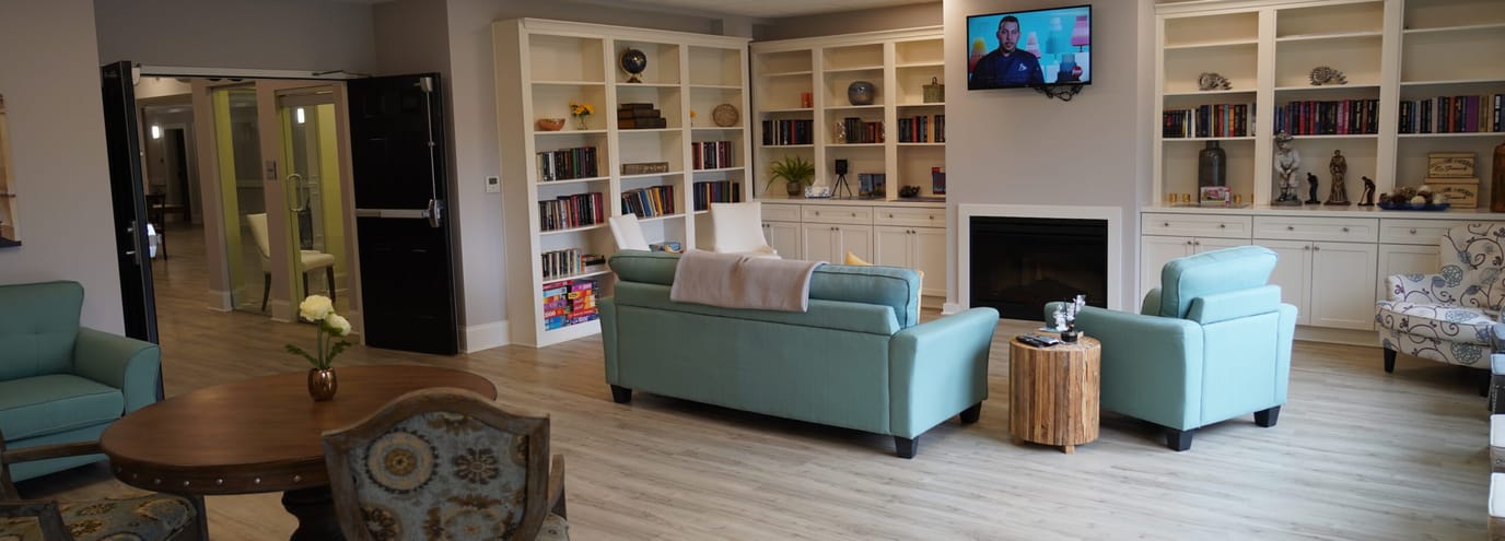 Cozy common area with seating and bookshelves