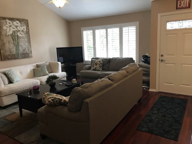Cozy common area with sofas and natural light.