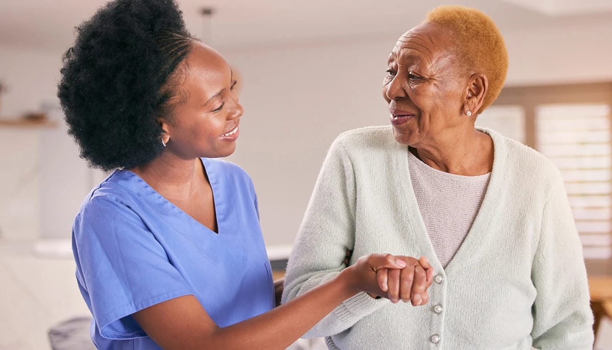 Staff member assisting a resident with a smile