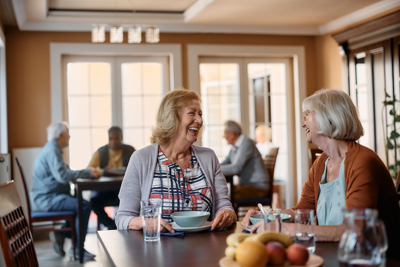 Two women enjoy a meal and conversation.