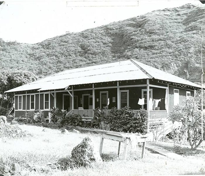Historic building surrounded by greenery.